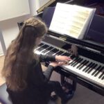 Schülerinnen und Schüler der Klasse von Andreas Lobisch präsentieren den neuen Flügel der Musikschule Lüdinghausen